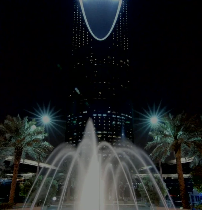 Kingdom Centre at night behind a lit fountain