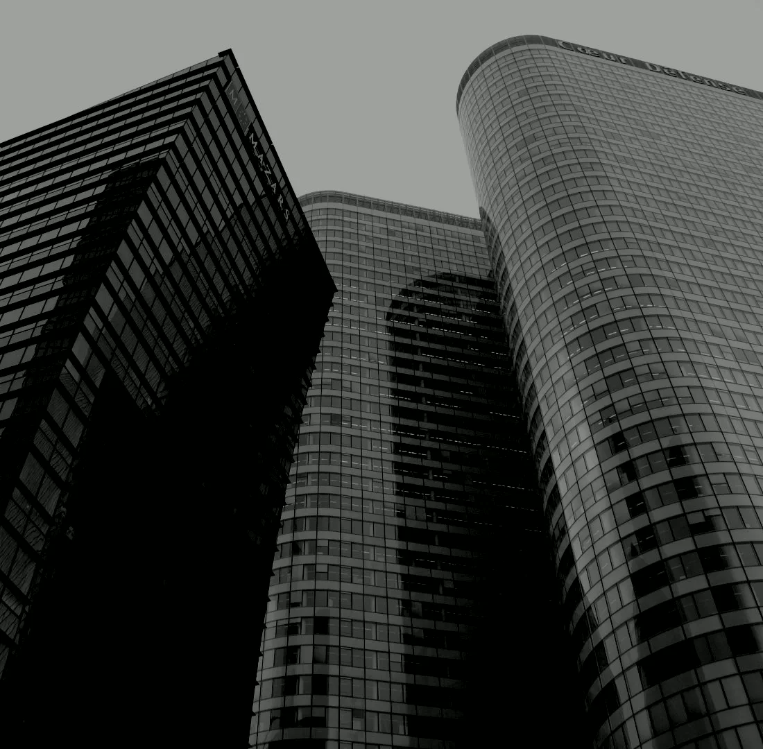 Looking up at the glass facades of modern office towers